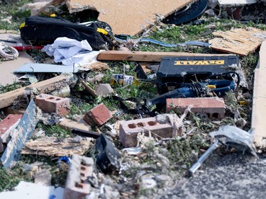 Power tools and a bottle of beer lie among debris at a home destroyed by a tornado in Dunrobin, Ont.,