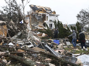 Damaged and devastated homes in Dunrobin Ontario Tuesday Sept 25, 2018. Families and friends go through the mess in hopes of finding personal belongings.