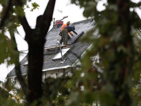 Crews fix roofs and clear debris of damaged and devastated homes in Dunrobin Ontario Tuesday Sept 25, 2018.   Tony Caldwell