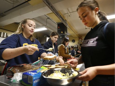 Glebe high school students volunteer in the kitchen at the Parkdale Food Centre in Ottawa Monday Sept 24, 2018.