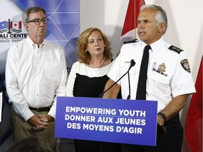 Ottawa police Chief Charles Bordeleau, Ottawa Mayor Jim Watson and Lisa MacLeod, minister of Children, Community and Social Services, are seen during an announcement on empowering youth at the Somali Centre for Family Services in Ottawa on Tuesday, Sept. 11, 2018.