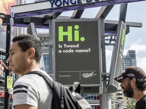 TORONTO, ONTARIO: SEPTEMBER 7, 2018--CANNABIS-Pedestrians walk Yonge Street at Dundas Square in Toronto with advertising for Tweed Cannabis in the background, Friday September 7, 2018.  [Peter J Thompson] [For National story by TBA/ational] ORG XMIT: POS1809071249362966