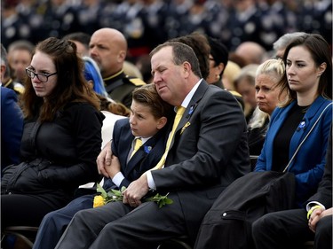 Steven Burns, husband of Fredericton Police Const. Sara Burns, embraces son Anderson during the Canadian Police and Peace Officers' Memorial Service.