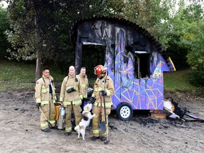 Ottawa firefighters, with Otis the dog, at scene of fire in robot trailer.