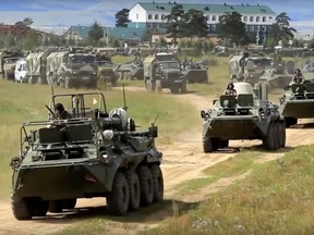 In this frame grab provided by Russian Defence Ministry Press Service on Tuesday, Sept. 11, 2018, Russian armoured personnel carriers roll during the military exercises in the Chita region, Eastern Siberia, during the Vostok 2018 exercises.
