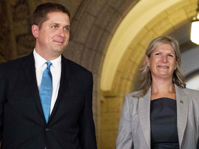 Conservative Party Leader Andrew Scheer walks with MP Leona Alleslev after she crossed the floor and joined the Conservative party on Sept. 17, 2018.