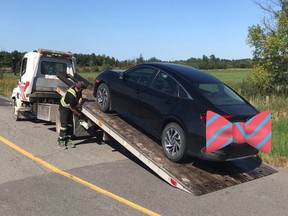 A digital bowtie covers the plates of a car stopped for stunt driving furing Ottawa police service's school zone blitz.