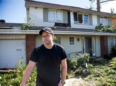 Ian MacArthur outside his damaged home on Riverbrook Rd in the Arlington Woods neighbourhood on Saturday morning as residents in Ottawa's west end deal with the aftermath of the twister that touched down on Friday afternoon.