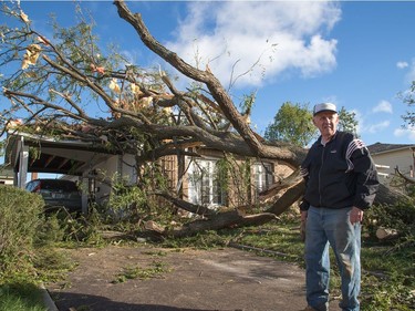 Phil Gallien stands on his driveway on Elvaston Ave on Saturday morning as residents in Ottawa's west end deal with the aftermath of the twister that touched down on Friday afternoon. Photo by Wayne Cuddington/ Postmedia