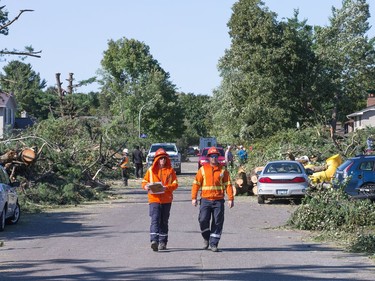 Hydro crews survey the damage on Parkland Cres as the region continues to deal with the after effects of the tornados that struck the region on Friday.