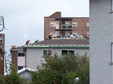 A roof is repaired in Gatineau on Saturday.