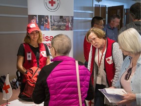 Canadian Red Cross volunteers listen to a resident at a City of Ottawa information session