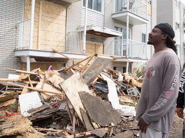 Idi Ngala looks over the severely damaged apartment complex he lived in on rue Daniel Johnston in Gatineau on Saturday.