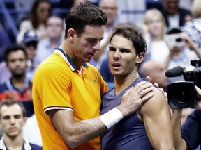 Juan Martin del Potro of Argentina talks with Rafael Nadal of Spain after Nadal retired from the match during the semifinals of the U.S. Open tennis tournament on Friday in New York.
