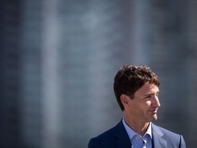 Prime Minister Justin Trudeau listens as B.C. Premier John Horgan responds to a question during a transit funding announcement in Surrey, B.C., on Tuesday September 4, 2018.