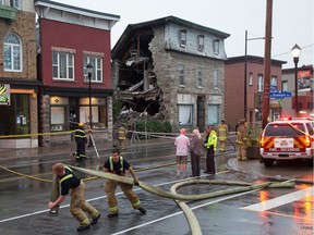 Emergency personnel deal with a collapsed wall on the Magee House