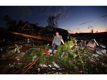 People collect personal effects from damaged homes following a tornado in Dunrobin, Ontario west of Ottawa on Friday, Sept. 21, 2018. A tornado damaged cars in Gatineau, Que., and houses in a community west of Ottawa on Friday afternoon as much of southern Ontario saw severe thunderstorms and high wind gusts, Environment Canada said.