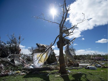 A child's blanket and building materials are tangled in a tree in a neighbourhood destroyed by a tornado in Dunrobin, Ont., west of Ottawa, on Saturday, Sept. 22, 2018. The storm tore roofs off of homes, overturned cars and felled power lines in the Ottawa community of Dunrobin and in Gatineau, Que.