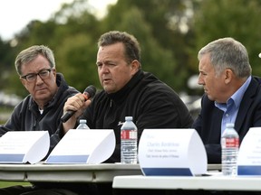 Bryce Conrad, president and CEO of Hydro Ottawa, speaks as Mayor Jim Watson, left, and Anthony DiMonte, Ottawa's general manager of emergency and protective services, listen during Sunday's news conference at Larkin House Community Centre.