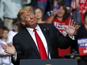President Donald Trump reacts to the playing of West Virginia's state song as he takes the stage during a rally in Wheeling, W.Va., Saturday, Sept. 29, 2018.
