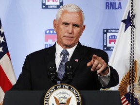 FILE - In this Aug. 24, 2018 file photo, Vice President Mike Pence gestures while speaking to the Republican National Lawyers Association in Washington. President Donald Trump is lashing out against the anonymous senior official who wrote an opinion piece in The New York Times. Washington is consumed by a wild guessing game as to the identity of the writer, and swift denials of involvement in the op-ed came Thursday from top administration officials, including from Vice President Mike Pence's office, Secretary of State Mike Pompeo and Dan Coats, director of national intelligence, and other Cabinet members.