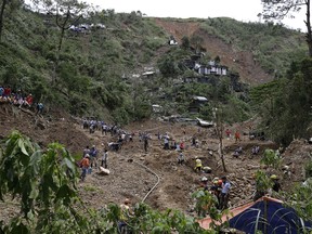 Rescuers continue searching for victims believed to be buried by a landslide after Typhoon Mangkhut lashed Itogon, Benguet province, northern Philippines on Monday, Sept. 17, 2018. Itogon Mayor Victorio Palangdan said that at the height of the typhoon's onslaught Saturday afternoon, dozens of people, mostly miners and their families, rushed into an old three-story building in the village of Ucab. The building, a former mining bunkhouse that had been transformed into a chapel, was obliterated when part of a mountain slope collapsed.