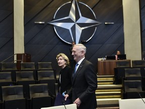 U.S. Defence Minister James Mattis (R) and U.S. Nato Ambassador Kay Bailey Hutchison arrive for a Defence Council meeting at Nato headquarters in Brussels on June 8, 2018.