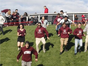 University of Ottawa Gee-Gees fans rush the field after the Gee-Gees win the Panda Game against the Carleton Ravens in Ottawa on Saturday, September 29, 2018.