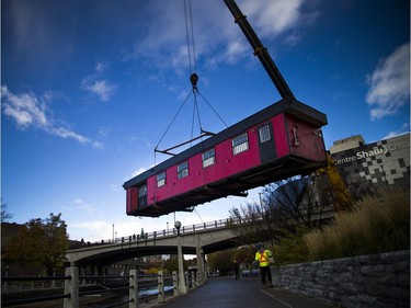 Rideau Canal Skateway trailers were lowered onto the edge of the canal on Saturday, with crews using a massive large crane.