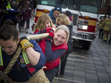 Teams of 10 came to Lansdowne Park to pull a 10 tonne fire truck 100 feet for the inaugural Ottawa Fire Truck Pull Sunday October 28, 2018. Teams compete to see who could pull the truck the fastest, raise the most money and demonstrate the best team spirit.  Helena Inaloz with Ottawa Fire Services (left) helped out the politicians team Sunday afternoon.   Ashley Fraser/Postmedia