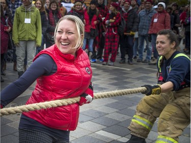 Teams of 10 came to Lansdowne Park to pull a 10 tonne fire truck 100 feet for the inaugural Ottawa Fire Truck Pull Sunday October 28, 2018. Teams compete to see who could pull the truck the fastest, raise the most money and demonstrate the best team spirit. A team of politicians had a little help from Ottawa Fire Services l-r Liberal MP Mona Fortier and Helena Inaloz.  Ashley Fraser/Postmedia