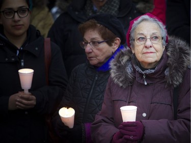 Fenja Brodo holds a candle at the Canadian Human Rights monument Sunday October 28, 2018, during a solidarity vigil against anti-semitism and white supremacy.   Ashley Fraser/Postmedia