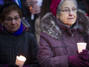Fenja Brodo holds a candle at the Canadian Human Rights monument Sunday October 28, 2018, during a solidarity vigil against anti-semitism and white supremacy.   Ashley Fraser/Postmedia