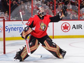 Senators netminder Craig Anderson makes a glove save against the Blackhawks in the third period of the season opener on Thursday.