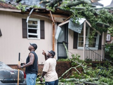 COLUMBIA, SC - OCTOBER 11: Wilker Ford, right, and Keito Jordan talk about nearby trees after remnants of Hurricane Michael sent a tree crashing into Jordan's neighbors' home October 11, 2018 in Columbia, South Carolina. The accident sent at least one person to the hospital.