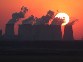 The sun sets behind the cooling towers of the Jaenschwalde coal-fired power plant on October 11, 2018 near Griessen, Germany.