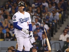 Enrique Hernandez of the Dodgers reacts after striking out during the eighth inning of Monday's game against the Brewers.