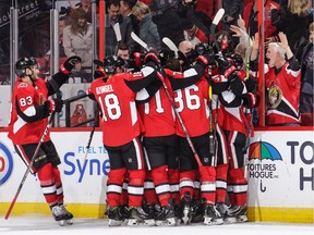 Mark Stone #61 of the Ottawa Senators is mobbed by his team mates after he score the overtime goal against the Montreal Canadiens for the win at Canadian Tire Centre on October 20, 2018 in Ottawa, Ontario, Canada.