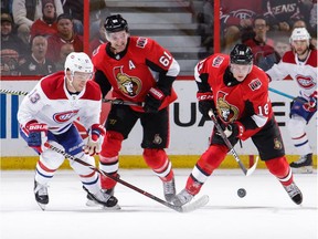 Senators winger Mark Stone, middle, and teammate Ryan Dzingel team up to harass the Canadiens' Max Domi during overtime of Saturday's game at Canadian Tire Centre.