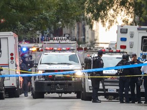 At left, a bomb disposal technician carries a package out of a U.S. Post Office facility at 52nd Street and 8th Avenue in Manhattan, October 26, 2018 in New York City.