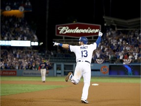 LOS ANGELES, CA - OCTOBER 26:  Max Muncy #13 of the Los Angeles Dodgers celebrates his eighteenth inning walk-off home run to defeat the the Boston Red Sox 3-2 in Game Three of the 2018 World Series at Dodger Stadium on October 26, 2018 in Los Angeles, California.