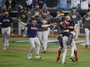 LOS ANGELES, CA - OCTOBER 28:  Christian Vazquez #7 jumps into the arms of Chris Sale #41 of the Boston Red Sox to celebrate their 5-1 win over the Los Angeles Dodgers in Game Five to win the 2018 World Series at Dodger Stadium on October 28, 2018 in Los Angeles, California.