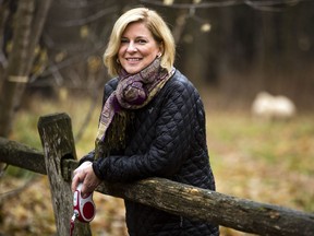 Carol Anne Meehan, who was unceremoniously laid off from her long-time job as news anchor at CTV Ottawa, takes a break to watch the water while on a walk with her dog, Gizmo, at her home near Manotick Thursday December 03, 2015.