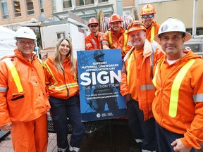 L to R: Darcy Provost, Kelsey Cabral, Devin Baxter, Cory Nixon, Mark Novosad, Colin Moran, Pat Rainey.  Hydro Line workers were set up on Sparks Street in Ottawa to get people to sign a petition to have a National Lineworker Appreciation day, October 02, 2018.