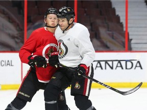 Brady Tkachuk, left, and Zack Smith battle for position during a drill in Senators practice at Canadian Tire Centre on Tuesday. Jean Levac/Postmedia