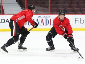 Thomas Chabot, left, and Brady Tkachuk, two of the young NHLers being counted to lead the Senators' turnaround, go one-on-one during practice at Canadian Tire Centre on Tuesday.