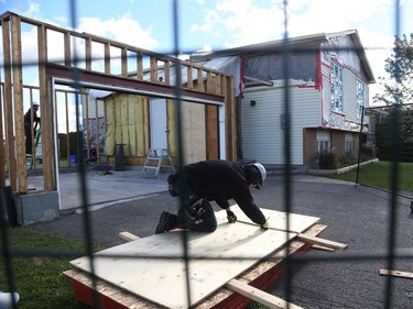 October 12, 2018: Construction workers hired by insurance companies rebuild a garage from a house in Dunrobin near Ottawa that was damaged by the tornado,.