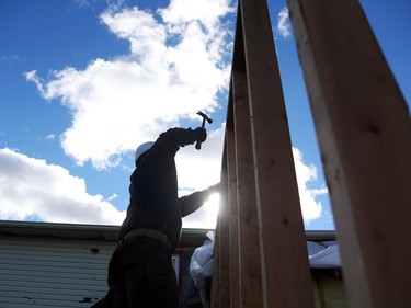 Look back at the Tornado and the communities affected by it. Construction workers hired by insurance companies rebuild a garage from a house in Dunrobin near Ottawa that was damaged by the tornado, October 12, 2018. Photo by Jean Levac/Postmedia   130194