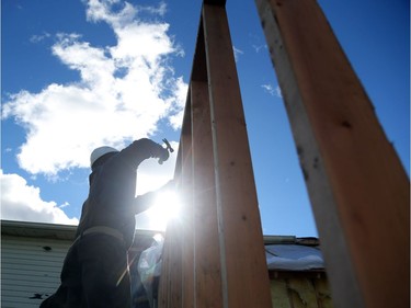 Look back at the Tornado and the communities affected by it. Construction workers hired by insurance companies rebuild a garage from a house in Dunrobin near Ottawa that was damaged by the tornado, October 12, 2018. Photo by Jean Levac/Postmedia   130194