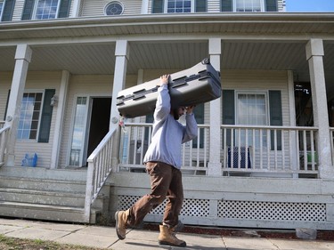 A mover removes personal belongings from a house in Dunrobin near Ottawa due to the damage caused by the tornado on October 12, 2018.